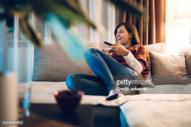 watching tv in hotel room - arts culture and entertainment stock pictures, royalty-free photos & images