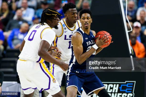Tigers forward Naz Reid and forward Aundre Hyatt defend Yale Bulldogs guard Miye Oni in the first round of the 2019 NCAA Photos via Getty Images...