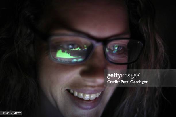 an adult female looking at financial graphs on a laptop. - low risk stock pictures, royalty-free photos & images