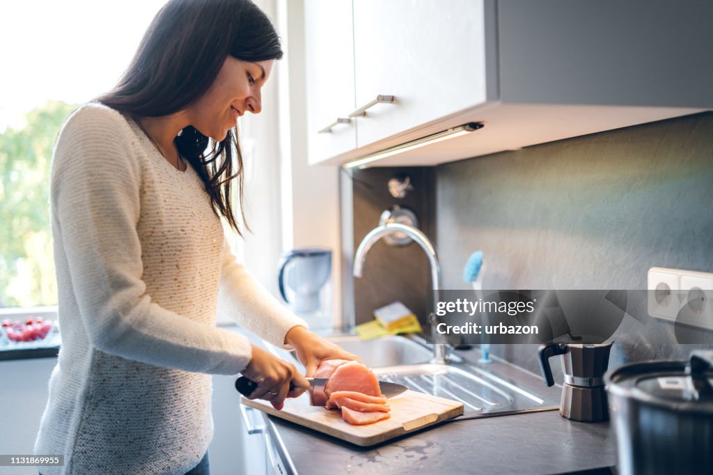 Woman cutting meat