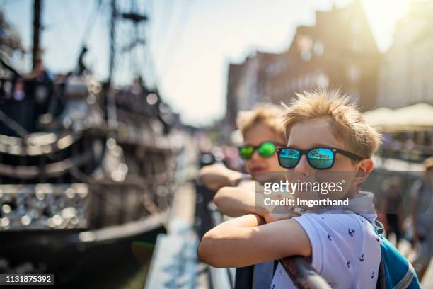 little boys sightseeing harbor of gdansk, poland - gdansk stock pictures, royalty-free photos & images