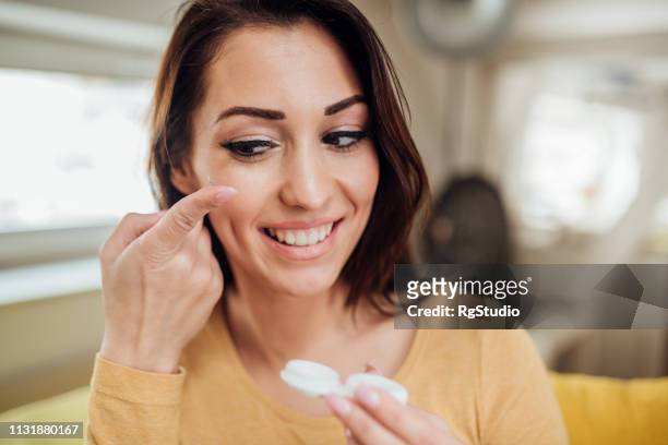 woman using contact lenses - contact lens stock pictures, royalty-free photos & images