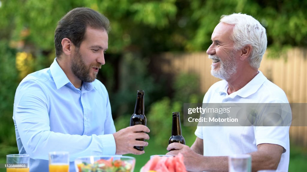 Son-in-law drinking beer with father-in-law, understanding and respect