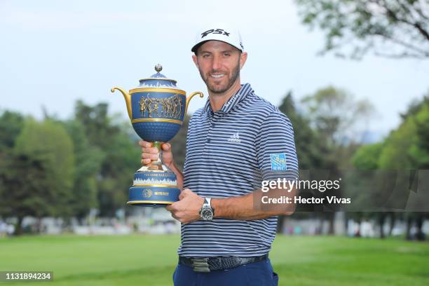 Dustin Johnson of the United States poses with the trophy after winning the World Golf Championships-Mexico Championship at Club de Golf Chapultepec...