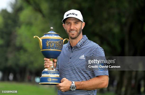 Dustin Johnson of the United States holds the Gene Sarazen Trophy after his five shot victory during the final round of the World Golf...