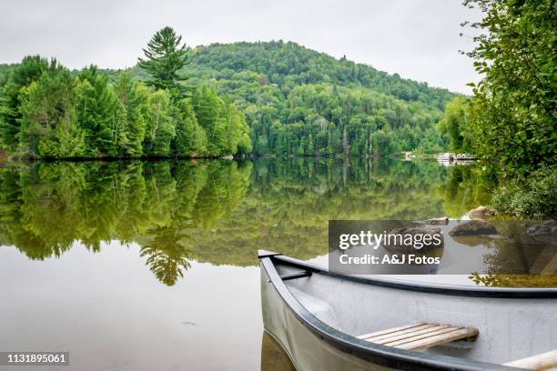 peaceful fishing lake with mountain range - long weekend canada stock pictures, royalty-free photos & images