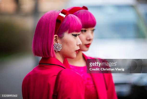 Twins with pink hair Ami Amiaya and Aya Amiaya wearing red blazer and dress seen outside Ferragamo on Day 4 Milan Fashion Week Autumn/Winter 2019/20...