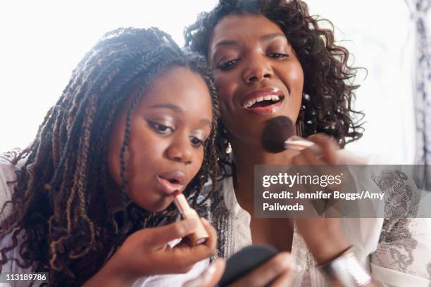 black mother and daughter putting on makeup - black powder stock pictures, royalty-free photos & images