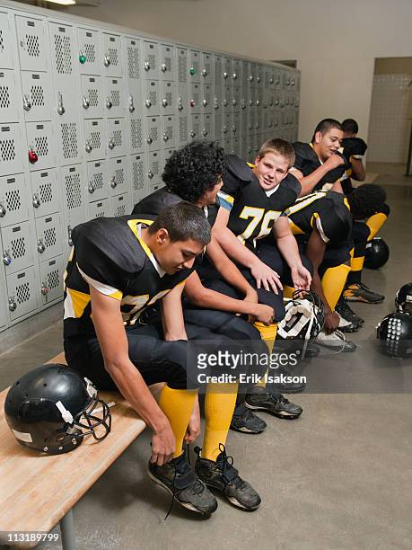 football players dressing in locker room - young boys changing in locker room fotografías e imágenes de stock
