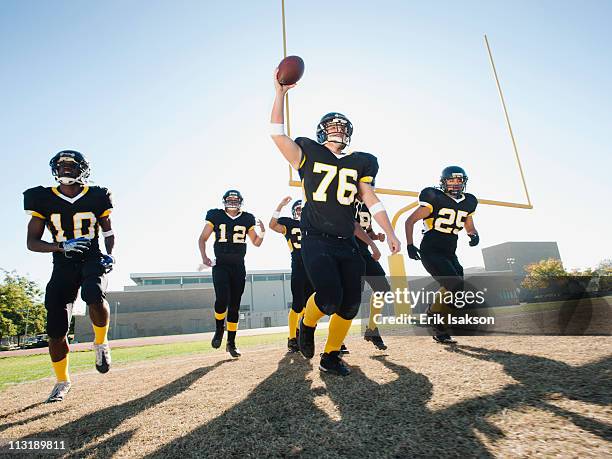 football players celebrating on football field - profundo jugador de fútbol americano fotografías e imágenes de stock