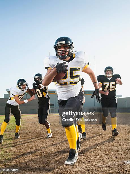 football players playing on football field - safety american football player stock pictures, royalty-free photos & images