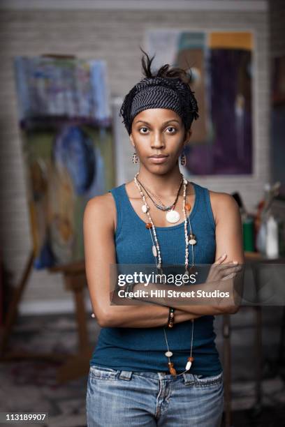 mixed race woman standing in artist's studio - hill street studios stock-fotos und bilder