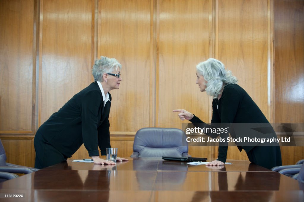 Caucasian businesswoman arguing in conference room