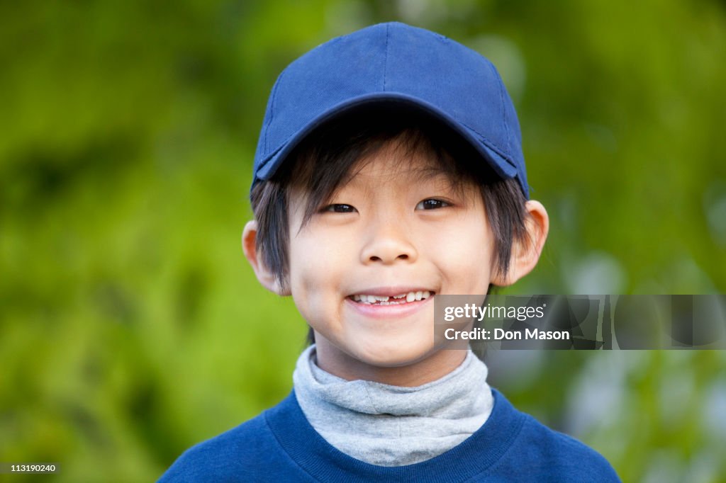 Smiling Korean boy in baseball cap
