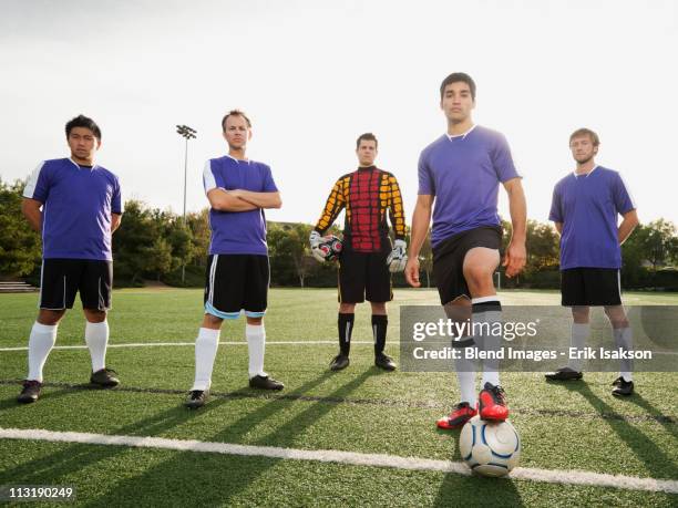 men standing with ball on soccer field - player portraits foto e immagini stock