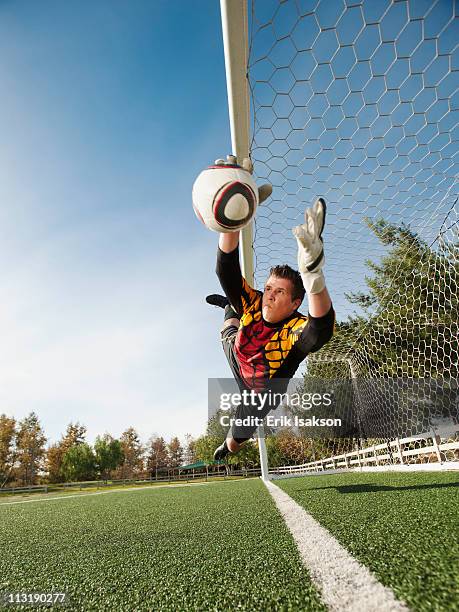 Goalkeeper Rushing Out Soccer Goalie Jumping To Catch Ball Photos and Premium High Res ...