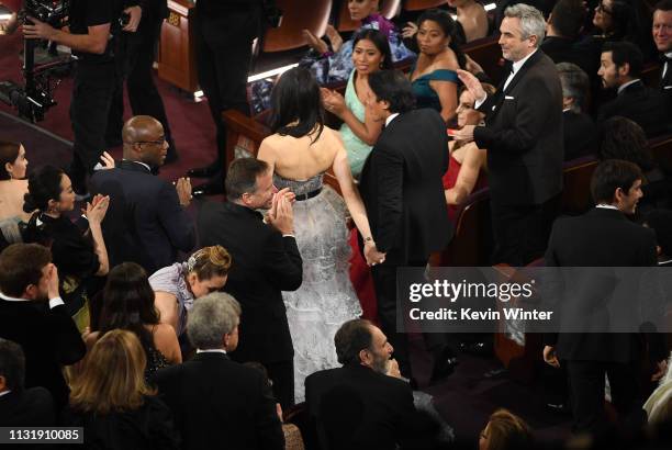 Elizabeth Chai Vasarhelyi and Jimmy Chin walk to the stage to accept the Documentary award for 'Free Solo' during the 91st Annual Academy Awards at...