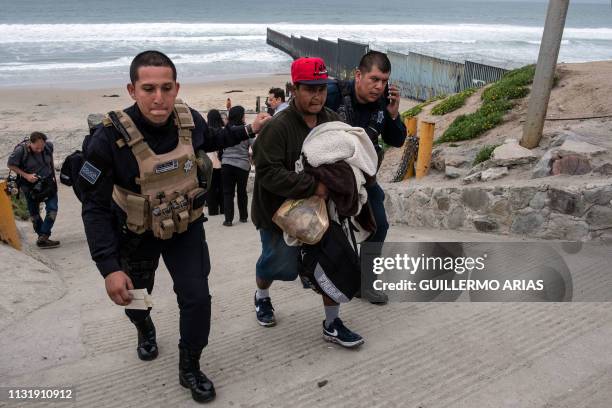 Central American migrant is taken into custody by Tijuana police after migrants faced US Border Patrol agents while trying to cross the US-Mexico...