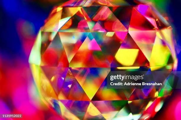 faceted crystal ball with vibrant light effects - crystal ball stock-fotos und bilder