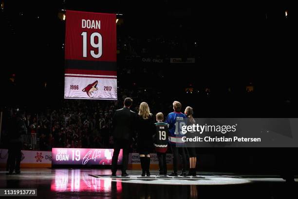 Shane Doan, wife Andrea and kids Josh, Carson and Karys observe as "Doan 19" banner is raised during a pregame ceremony to honor Shane Doan and...