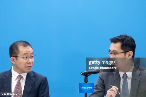 Ma Huateng, chairman and chief executive officer of Tencent Holdings Ltd., right, speaks with Martin Lau, president, during a news conference in Hong...