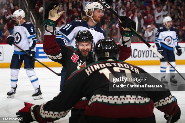 Brad Richardson of the Arizona Coyotes celebrates with Vinnie Hinostroza after Richardson scored a goal against the Winnipeg Jets during the first...