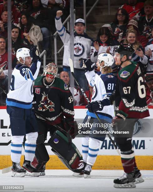 Patrik Laine of the Winnipeg Jets celebrates with Kyle Connor after scoring a goal against goaltender Darcy Kuemper of the Arizona Coyotes during the...