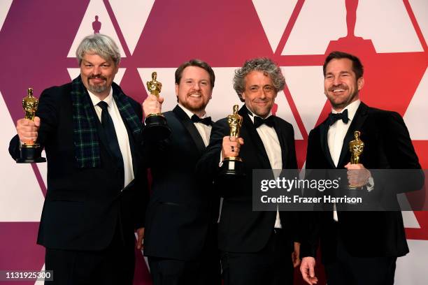 Ian Hunter, J.D. Schwalm, Paul Lambert, and Tristan Myles, winners of Best Visual Effects for "First Man," pose in the press room during the 91st...