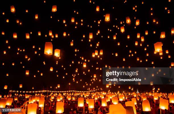 reflection of numerous lanterns in the sky, yeepeng festival , chiangmai, thailand - paper lanterns stock pictures, royalty-free photos & images