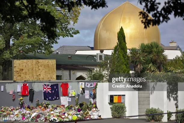 Flowers are placed in front of Al Noor mosque during first Friday Prayer after twin terror attacks targeting mosques in Christchurch, New Zealand on...