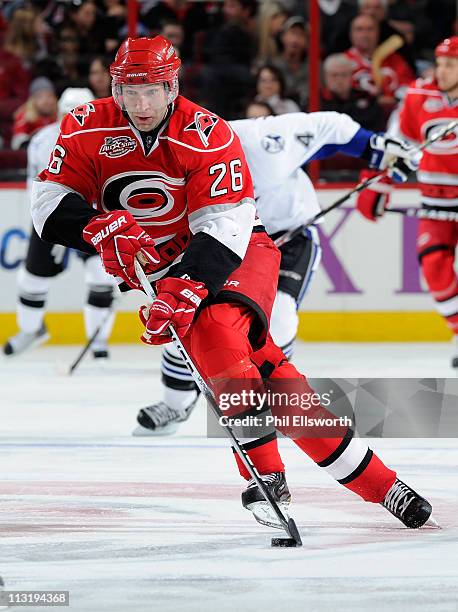 Erik Cole of the Carolina Hurricanes brings the puck up ice against the Tampa Bay Lightning during an NHL game on March 26, 2011 at RBC Center in...