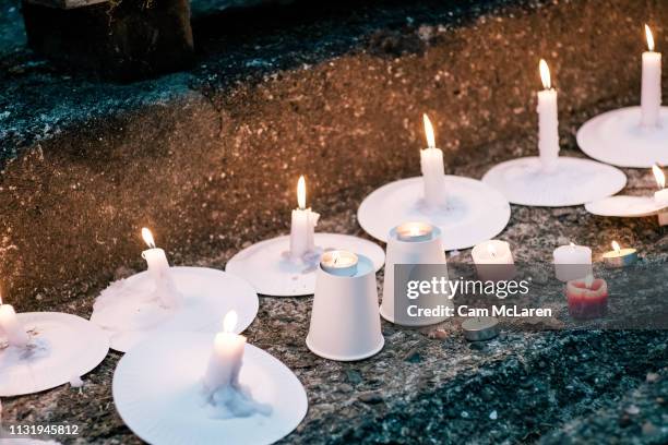 Candles are lit as people attend a vigil for the lives taken in the Christchurch terror attacks at the Auckland Domain on March 22, 2019 in Auckland,...