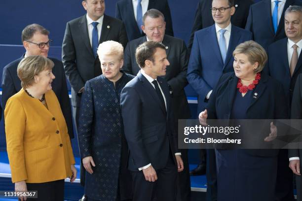 Angela Merkel, Germany's chancellor, from left front row, speaks with Dalia Grybauskaite, Lithuania's president, alongside Emmanuel Macron, France's...