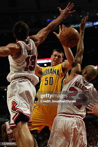 Tyler Hansbrough of the Indiana Pacers looses control of the ball under pressure from Joakim Noah and Taj Gibson of the Chicago Bulls in Game Five of...