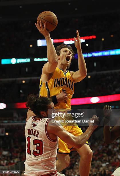 Joakim Noah of the Chicago Bulls fouls Mike Dunleavy of the Indiana Pacers as he shoots in Game Five of the Eastern Conference Quarterfinals in the...