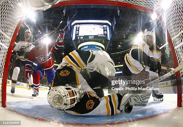 Scott Gomez of the Montreal Canadiens celebrates as Tim Thomas of the Boston Bruins looks back into his net to see the puck in Game Six of the...