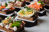 Set of scandinavian snack. Smorrebrod. Traditional Danish open sanwiches, dark rye bread with different topping