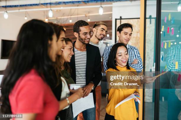 latina leadership in business - group of mexican, cuban and international coworkers in brainstorming session - initiative stock pictures, royalty-free photos & images