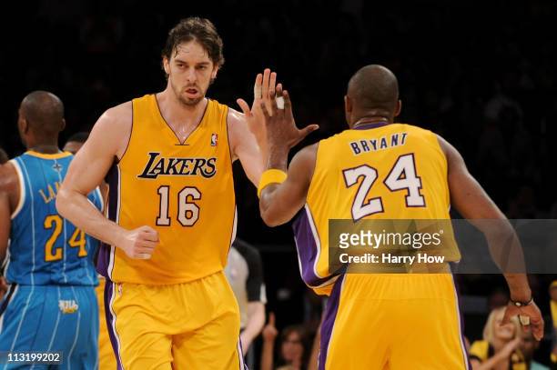 Pau Gasol reacts with teammate Kobe Bryant of the Los Angeles Lakers in the third quarter while taking on the New Orleans Hornets in Game Five of the...
