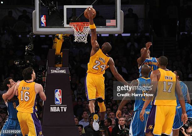 Kobe Bryant of the Los Angeles Lakers dunks the ball with his left hand in the lane in the third quarter against the New Orleans Hornets in Game Five...