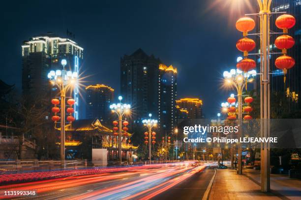 traffic car light trails on a road at night with chinese lanterns - chinese festival stock pictures, royalty-free photos & images