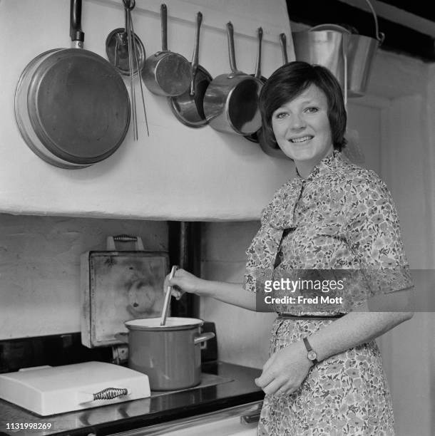 English cook and television presenter Delia Smith preparing food in a kitchen, UK, 19th August 1975.