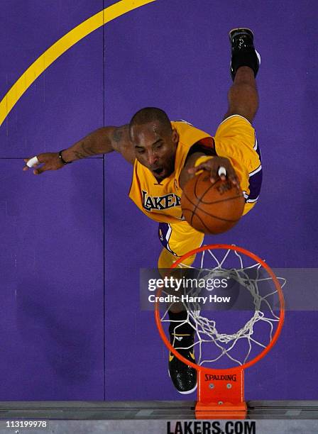 Kobe Bryant of the Los Angeles Lakers dunks the ball with his left hand in the lane in the third quarter against the New Orleans Hornets in Game Five...