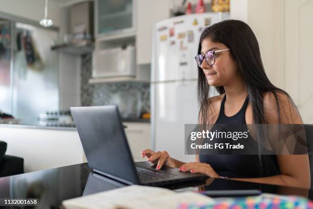 young woman using laptop at home - job search stock pictures, royalty-free photos & images