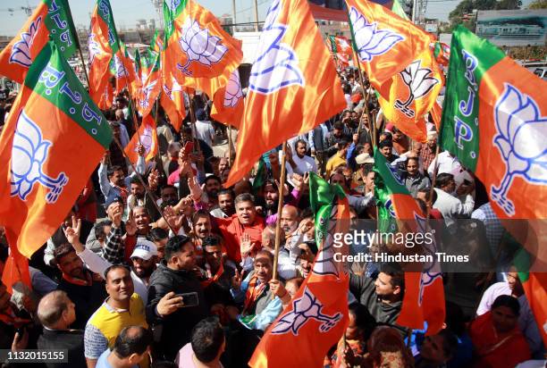 Bharatiya Janata Party supporters seen along with Union Minister and BJP Candidate Jugal Kishore Sharma as he arrives to file his nomination for...