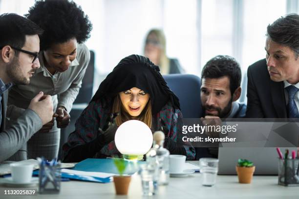 young fortune teller predicting the future for business team. - medium group of people imagens e fotografias de stock