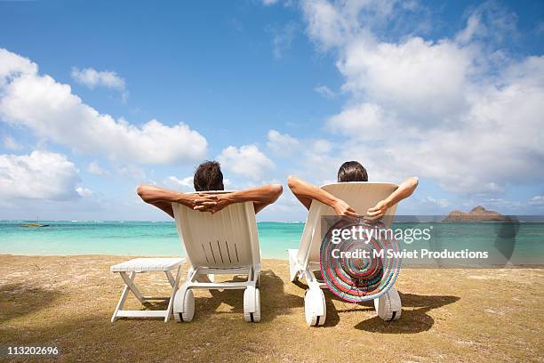 couple relaxing - beach relaxing stock pictures, royalty-free photos & images