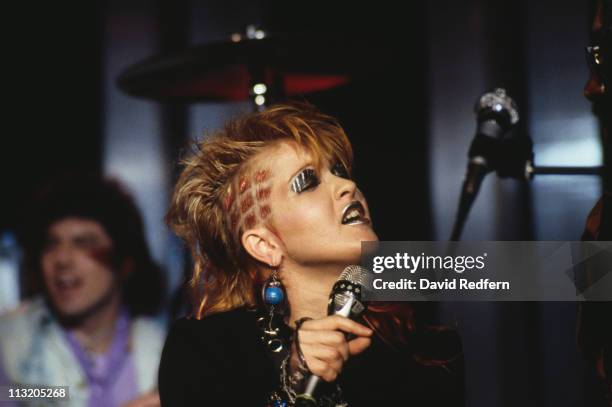 Cyndi Lauper, U.S. Singer-songwriter, singing into a microphone, silver make-up on her lips and eyelids, at the Montreux Rock Festival, in Montreux,...