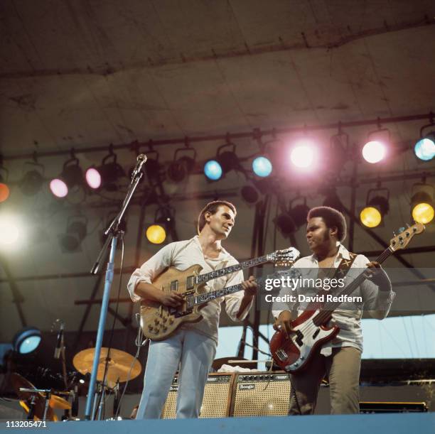 John McLaughlin, British jazz guitarist, playing a double-necked guitar, and and bassist Ralphe Armstrong during a live concert performance with the...