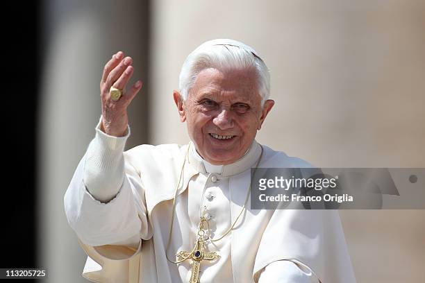 Pope Benedict XVI gestures to the faithful gathered in St. Peter's Square as he attends his weekly audience on April 27, 2011 in Vatican City,...